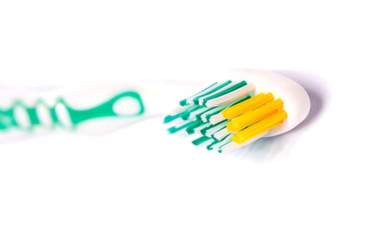 Close up view of a tooth brush isolated on a white background.