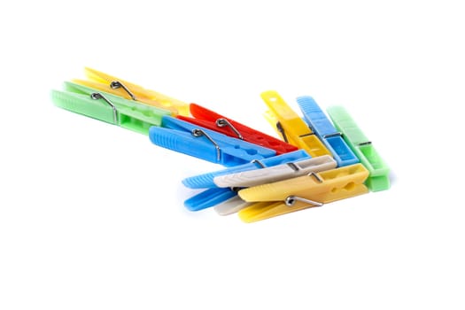 Close up view of some colorful cloth pegs isolated on a white background.