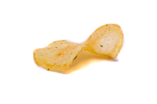 Close view of a single potato chip isolated on a white background.