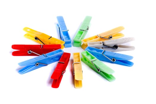 Close up view of some colorful cloth pegs isolated on a white background.