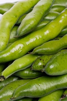Close up view of some broad beans isolated on a white background.