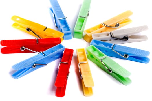 Close up view of some colorful cloth pegs isolated on a white background.