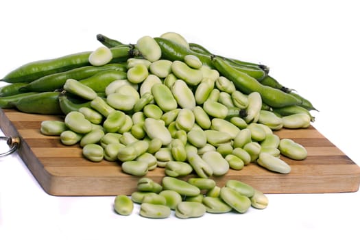 Close up view of some broad beans isolated on a white background.