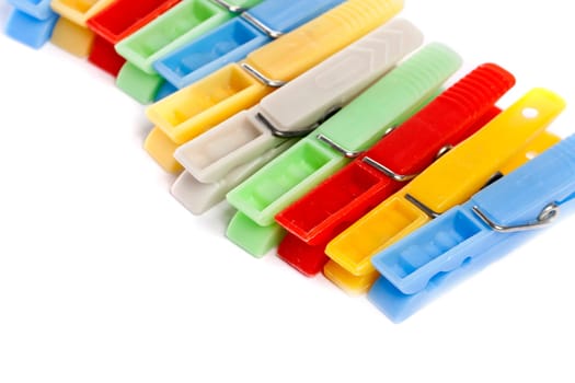 Close up view of some colorful cloth pegs isolated on a white background.