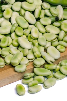 Close up view of some broad beans isolated on a white background.
