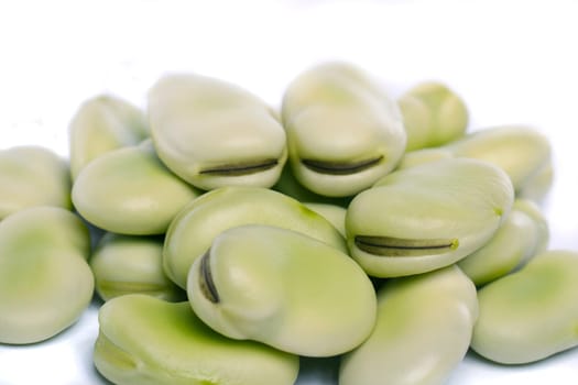 Close up view of some broad beans isolated on a white background.
