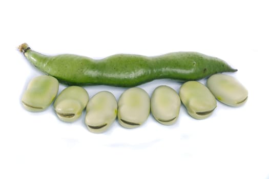 Close up view of some broad beans isolated on a white background.