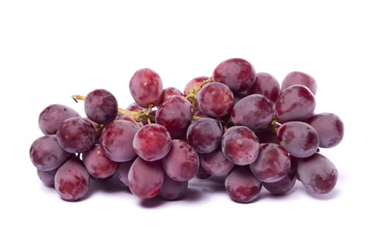 Close up view of some red wine grapes isolated on a white background.