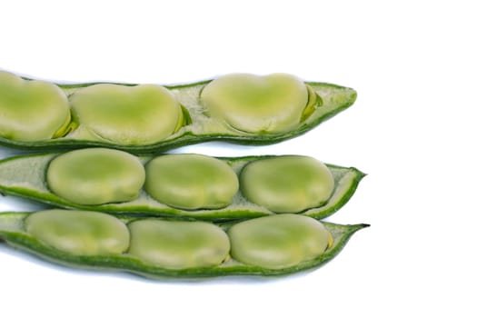 Close up view of some broad beans isolated on a white background.