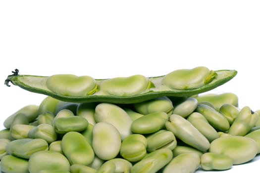Close up view of some broad beans isolated on a white background.