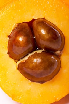 Close up view of some loquat fruit isolated on a white background.
