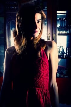 View of a beautiful young girl in a red dress on a living room.