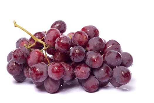 Close up view of some red wine grapes isolated on a white background.