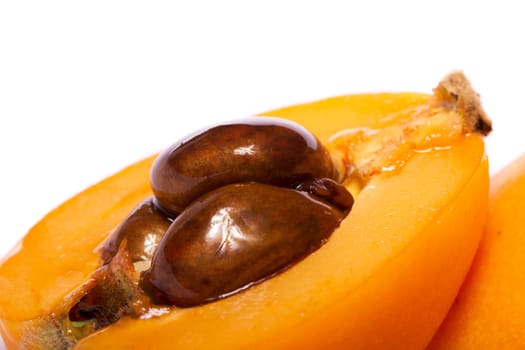 Close up view of some loquat fruit isolated on a white background.