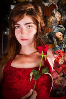 View of a beautiful young girl in a red dress on a living room.