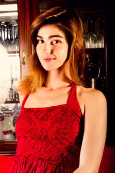 View of a beautiful young girl in a red dress on a living room.