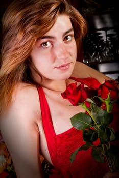 View of a beautiful young girl in a red dress on a living room.