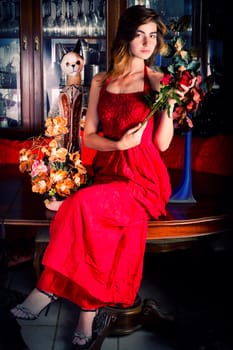 View of a beautiful young girl in a red dress on a living room.