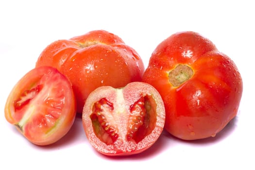 Close up view of a bunch of red tomatoes isolated on a white background.