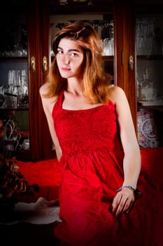View of a beautiful young girl in a red dress on a living room.