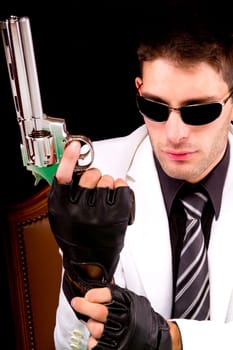 View of a white suit gangster man holding a gun.