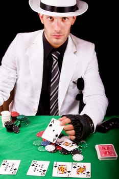 View of a gangster man playing some cards and poker.