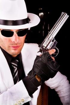 View of a white suit gangster man holding a gun.