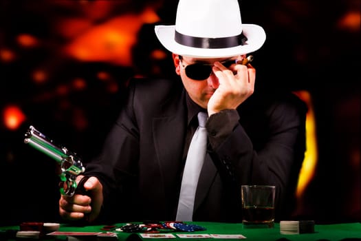 View of a gangster man playing some cards and poker.