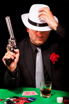 View of a dark suit gangster man holding a gun.