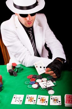 View of a gangster man playing some cards and poker.