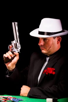 View of a dark suit gangster man holding a gun.