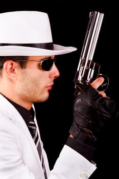 View of a white suit gangster man holding a gun.