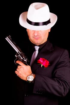 View of a dark suit gangster man holding a gun.