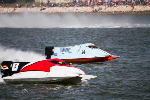 View of two powerboats racing on a lake in Portugal.