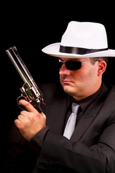 View of a dark suit gangster man holding a gun.
