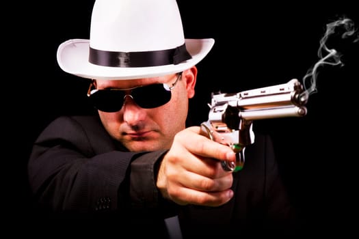 View of a white suit gangster man holding a gun.