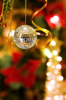Christmas magic with disco ball decoration and golden ribbons.