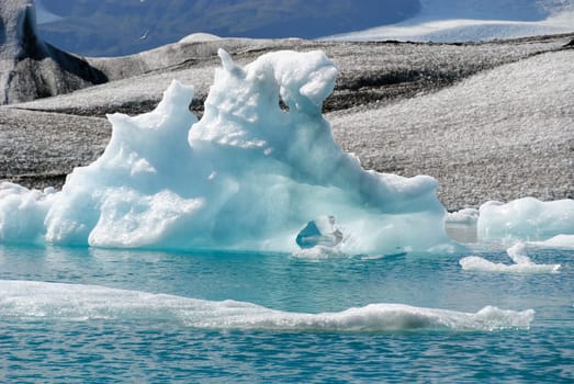 Iceberg reflections on the calm water of the lake Jokulsarlon