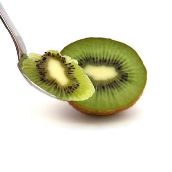 A kiwi half with a spoon