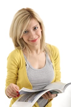 A young blonde checking out the magazine and looking at the camera.