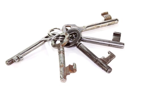 An old bunch of keys against a white background