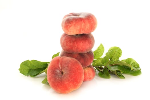 fresh mountain peaches and leaves against white background