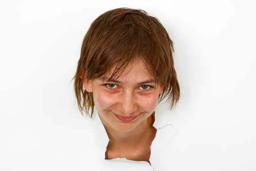 Young woman looking out of white paper