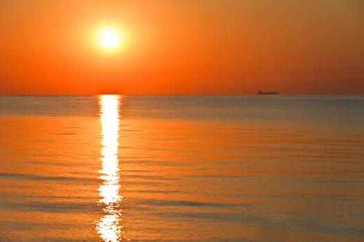 reflection of the sun at sunrise at sea