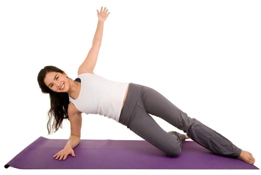 A young beautiful brunette is exercising and stretching.