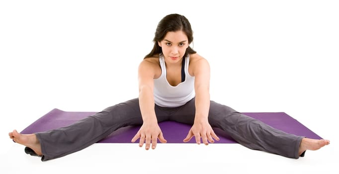 A young beautiful brunette is exercising and stretching.