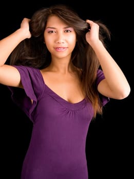 A beautiful young lady in a purple dress is looking at the camera.