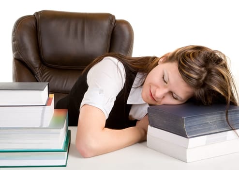 An exhausted female student is sleeping on her study books.