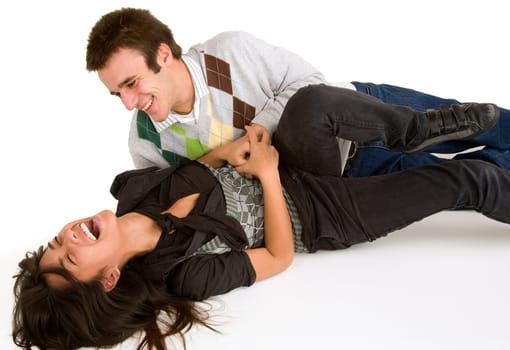 A youn girl is being tickled by a young man.