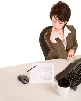 An attractive businesswoman is reading a document.